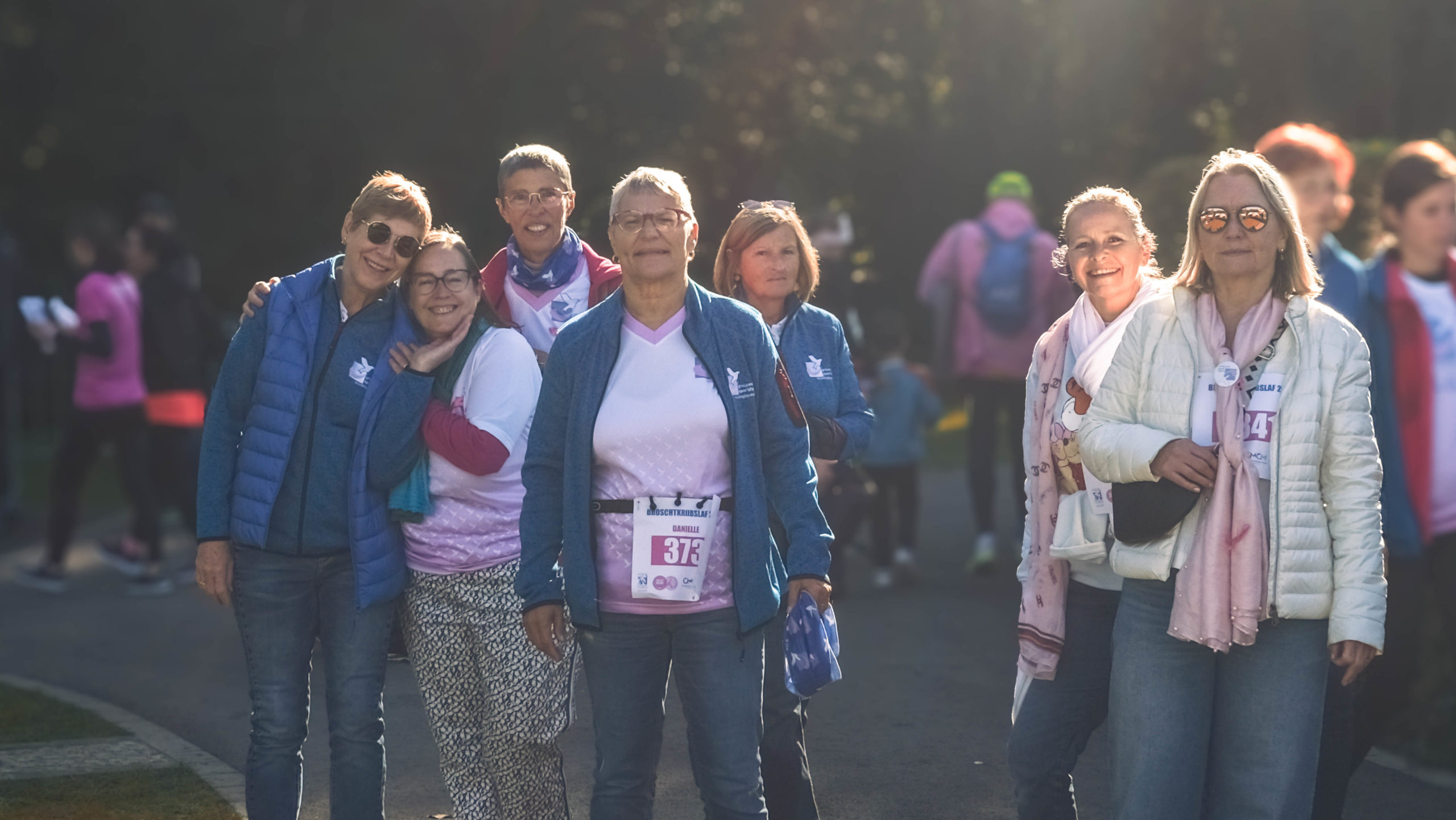 A group of ALGSO members smiling before crossing the finish line at the Broschtkriibslaf 2024