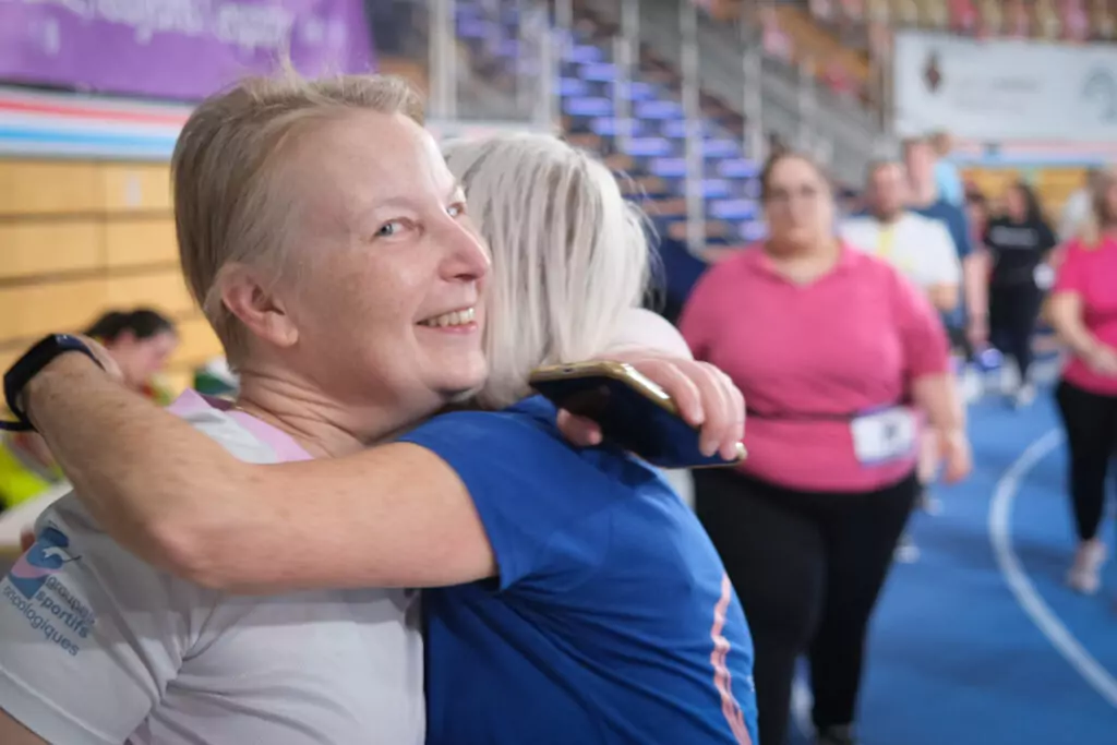 Two ALGSO members hugging as they relay each other at the Relais pour la Vie 2026 Luxembourg.
